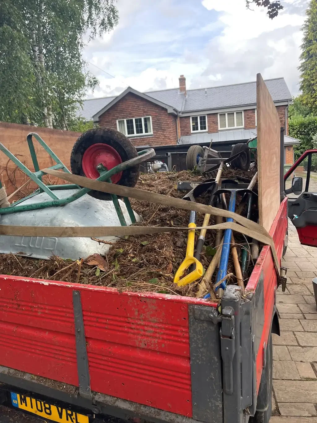 Full truck load — timber and waste piled high in Mr. Tippy's tipper